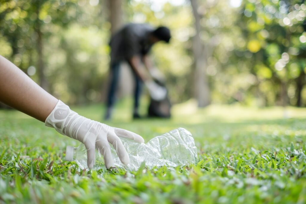 garbage collection, volunteer team pick up plastic bottles, put garbage in black garbage bags